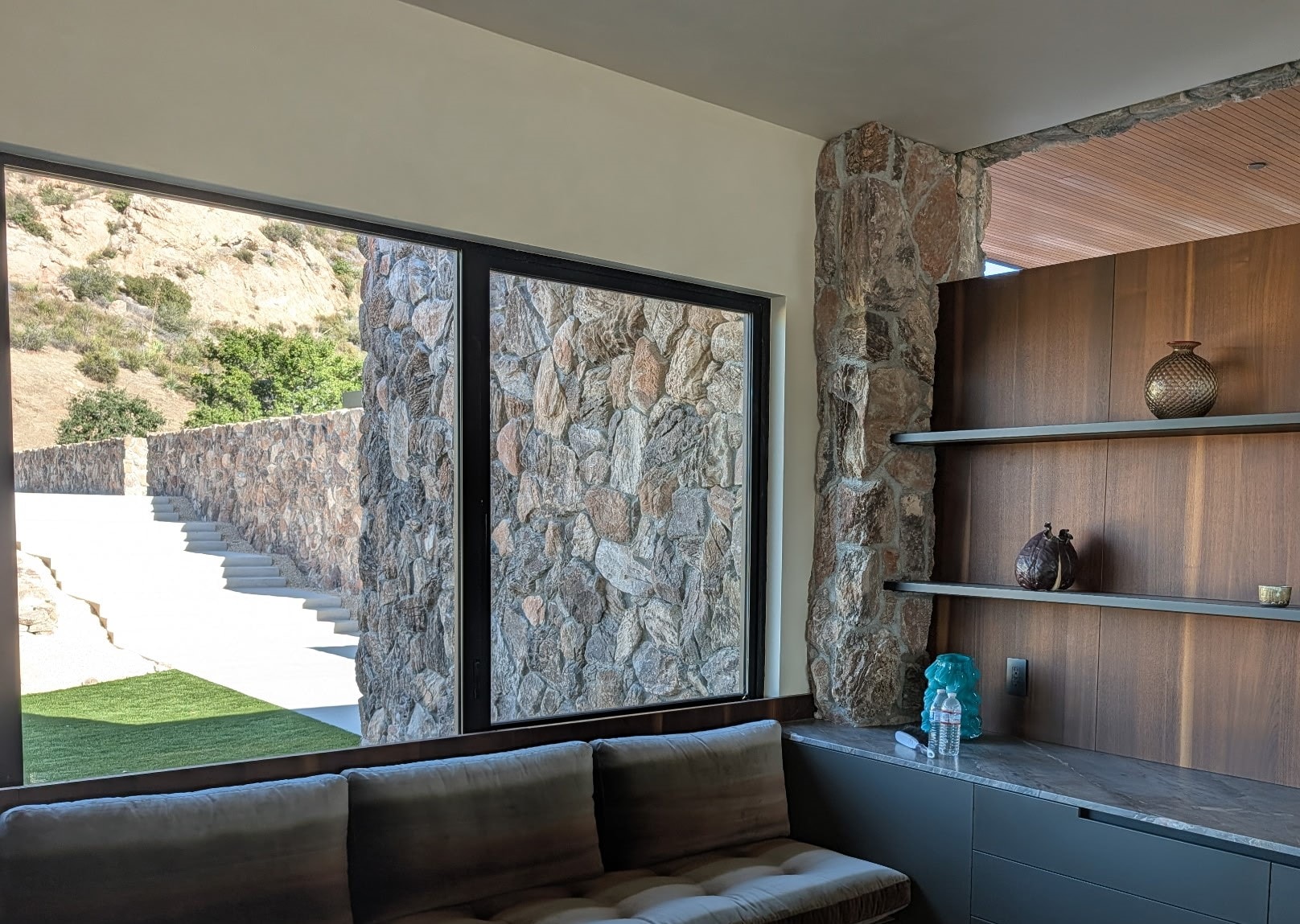 Baja Drift thin veneer — Malibu living room stone column with built-in shelving