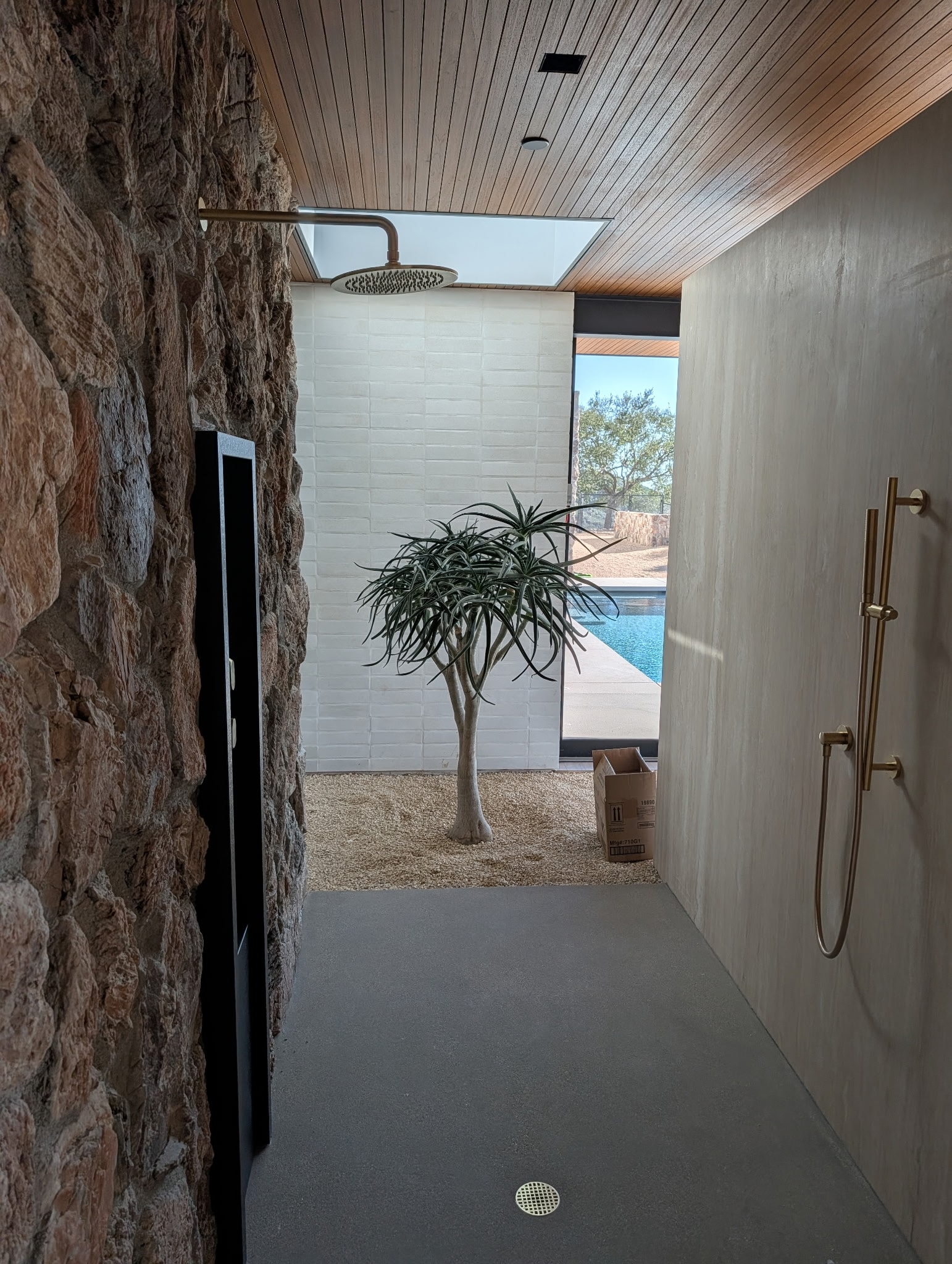 Baja Drift thin veneer — Malibu luxury shower with stone accent wall